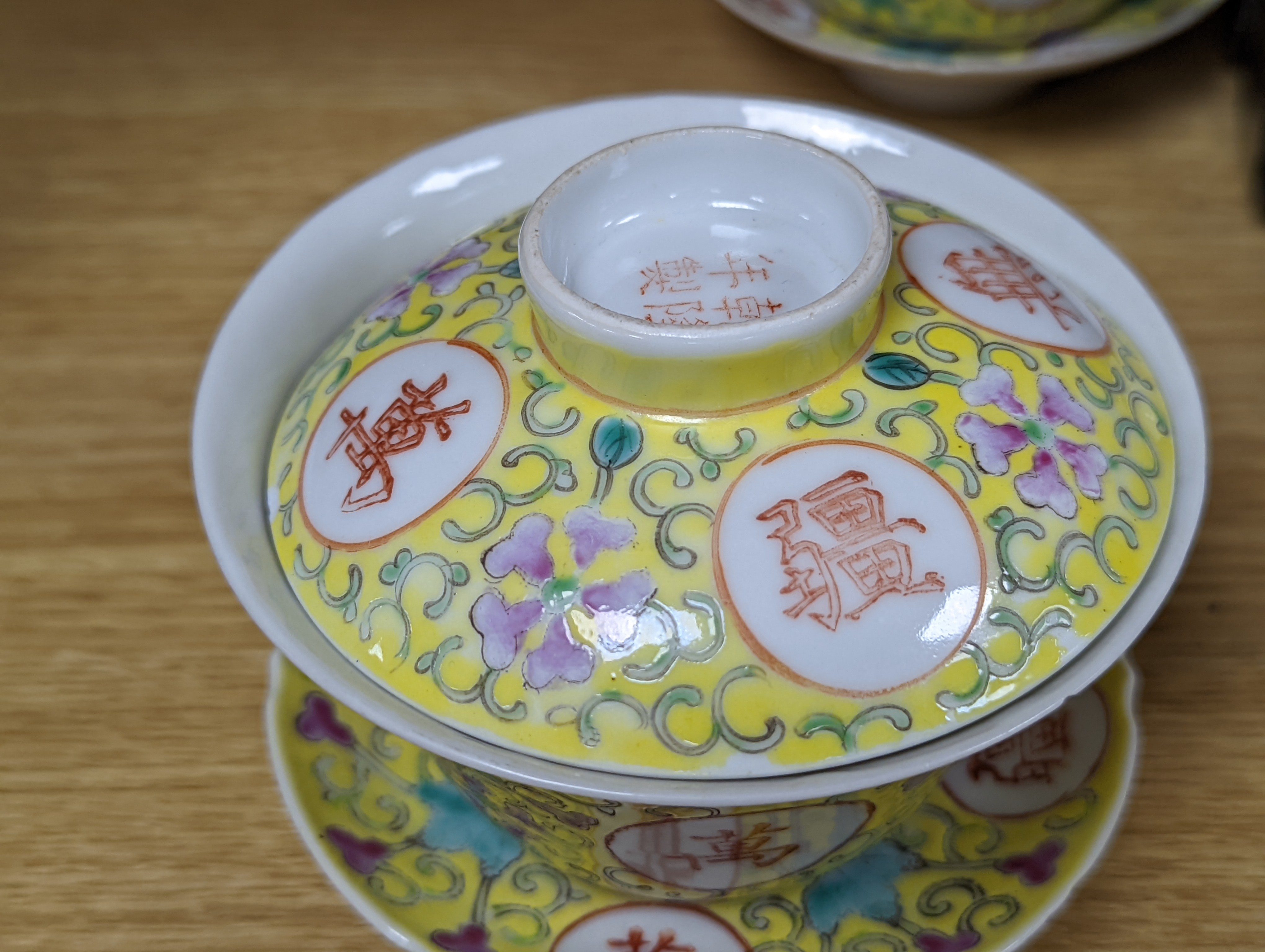 A pair of Chinese enamelled porcelain rice bowls, covers and stands and an odd bowl